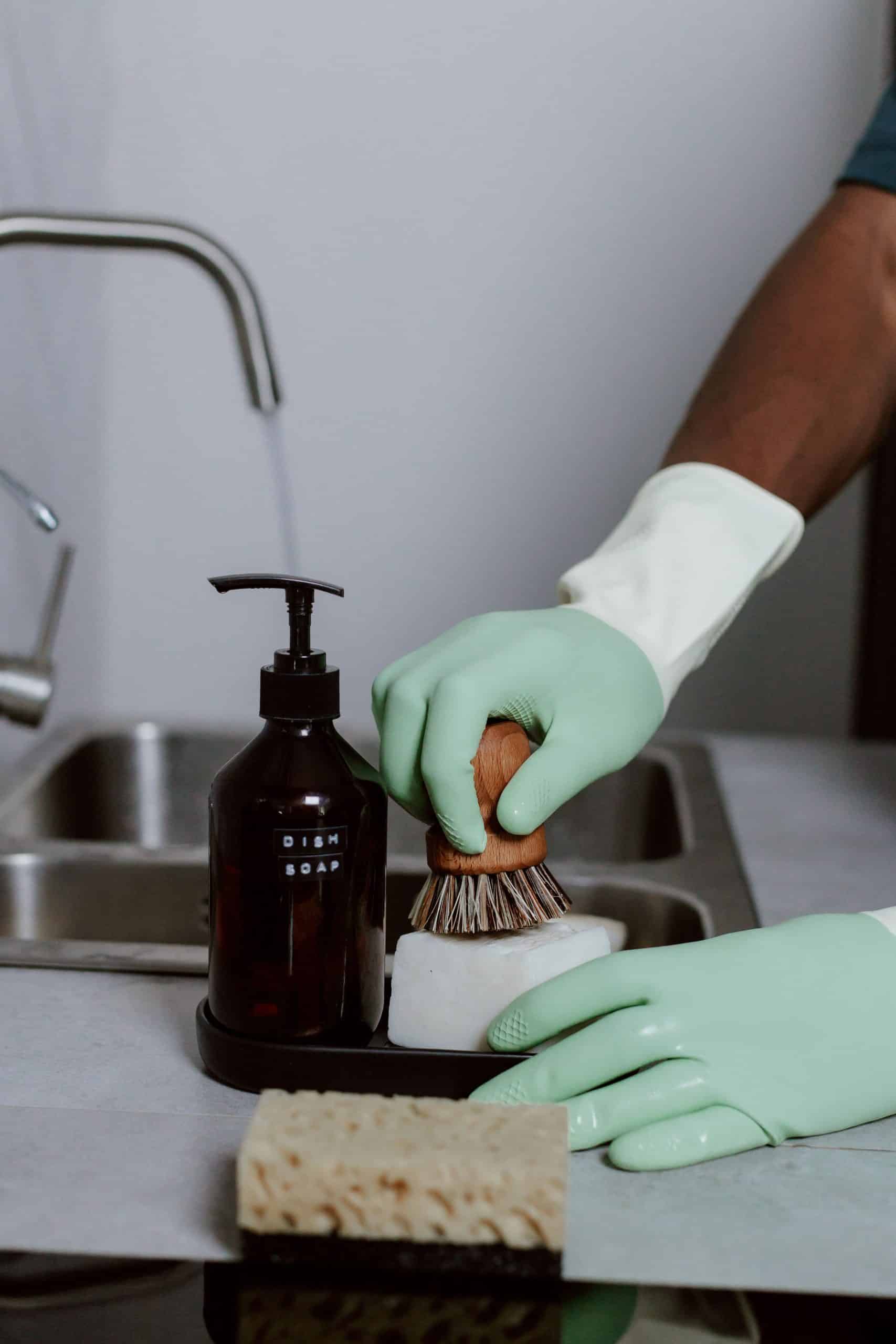 Wearing gloves while washing dishes to protect a gel manicure