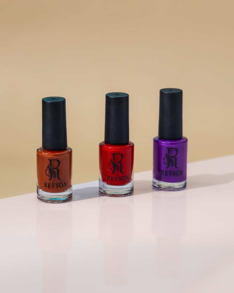 Rows of colorful nail gel and polish bottles from different brands