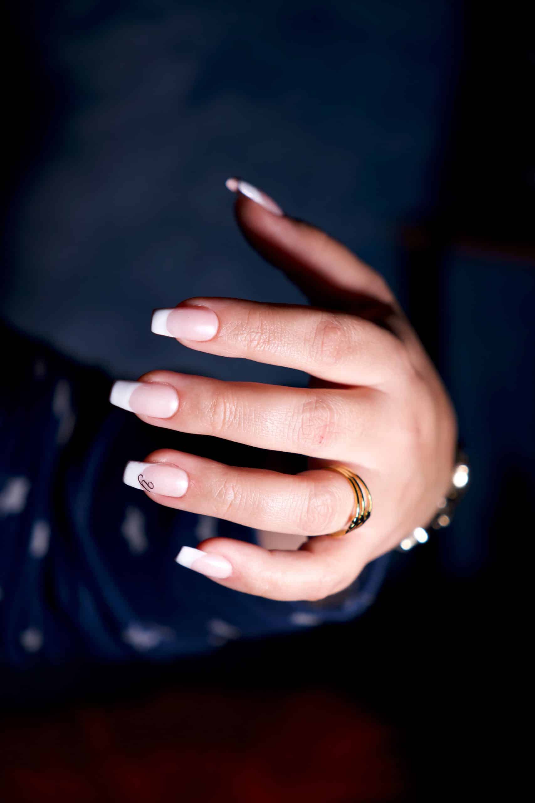 Finished French manicure showing the light, natural look of a soft gel tip set