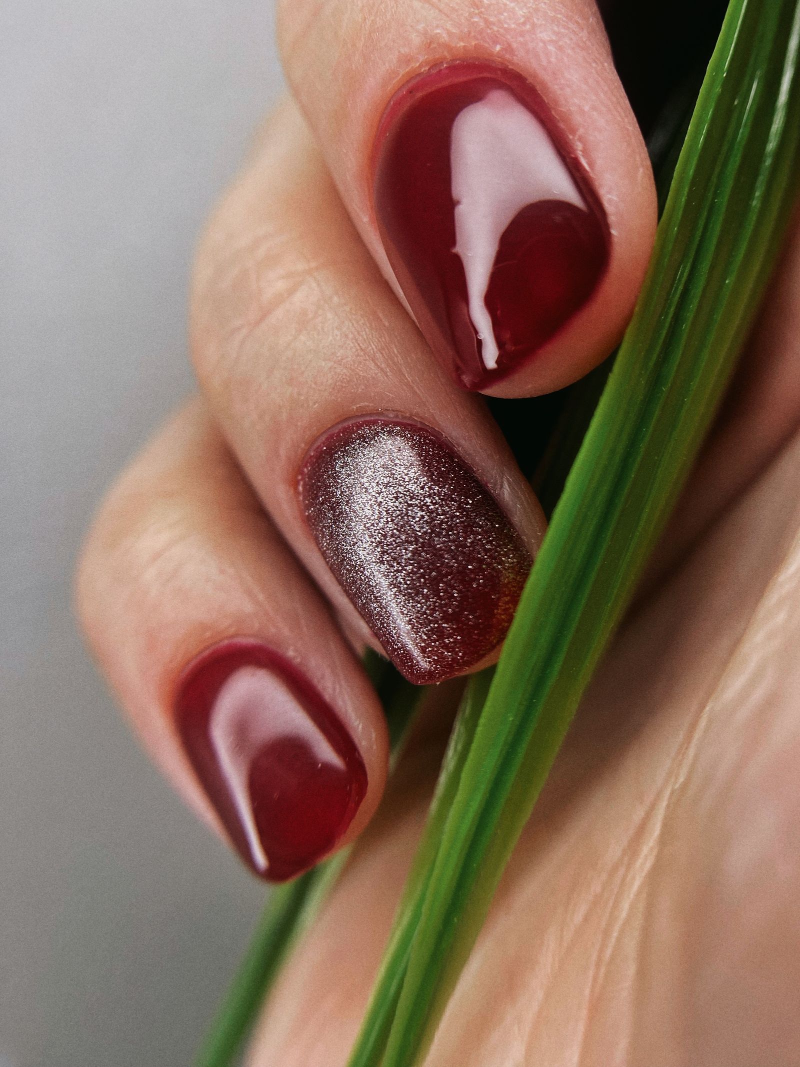 Elegant glossy red manicure, the polish look often confused with the cuticle technique