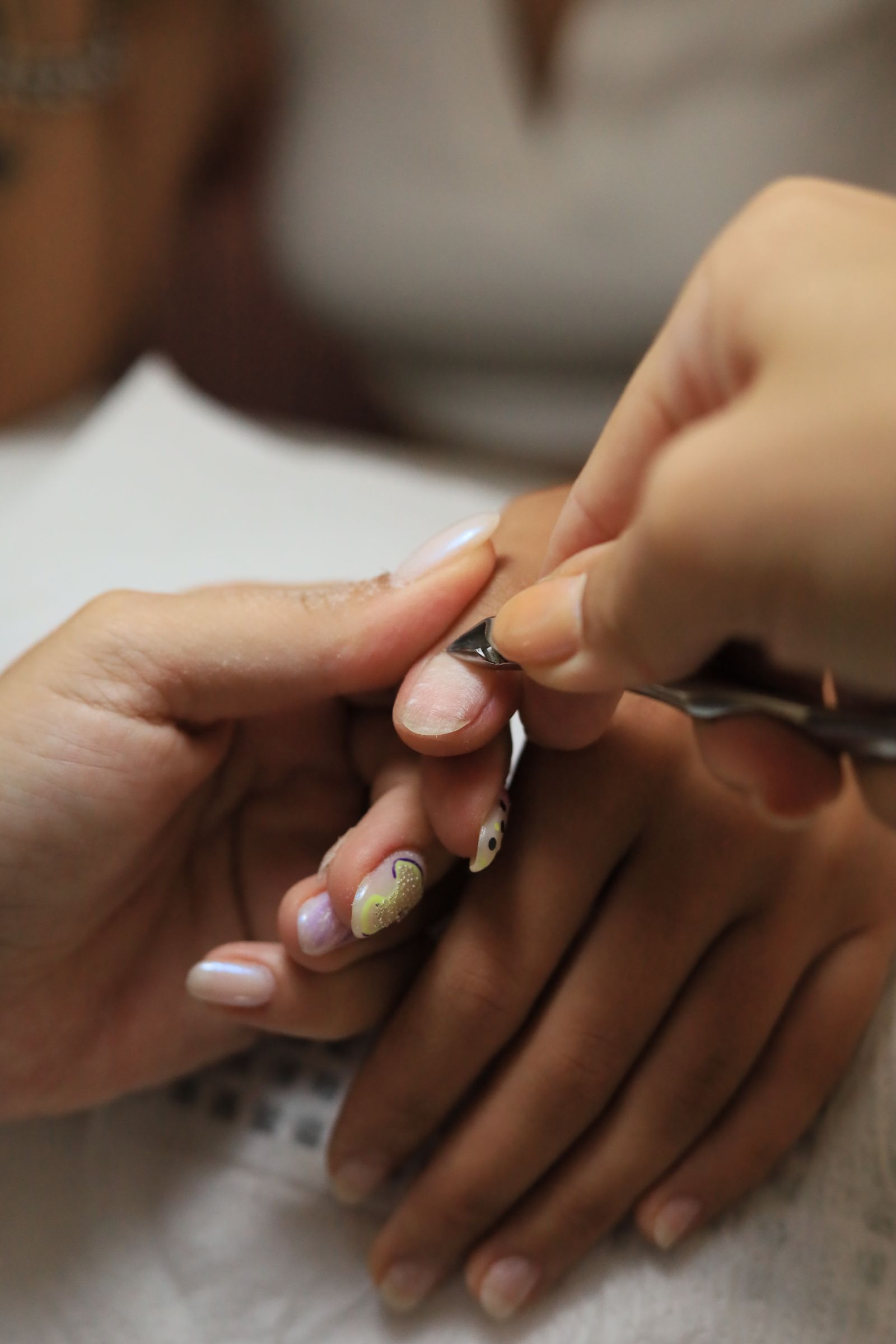 Close-up of dry cuticle work during a manicure service