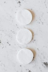 Cotton pads soaked in pure acetone are wrapped around the nail during soak-off
