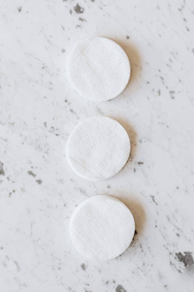 Cotton pads soaked in pure acetone are wrapped around the nail during soak-off