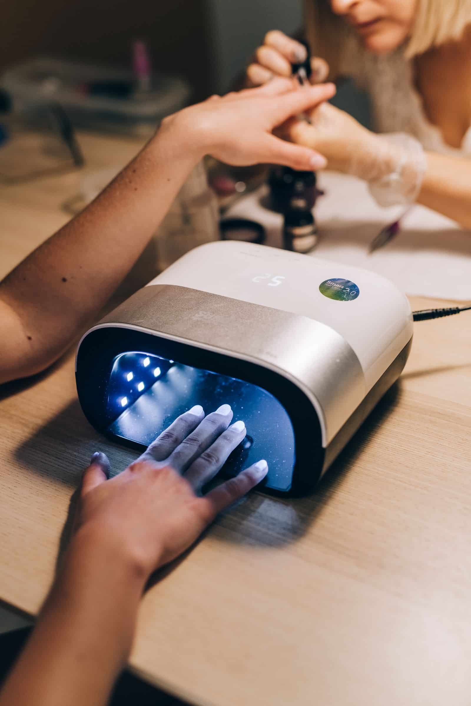 Nail dryer in use, a common accessory included in gel nail kits