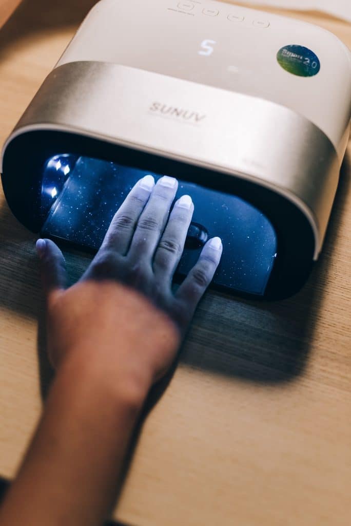 Hand placed inside a UV nail lamp to cure gel polish