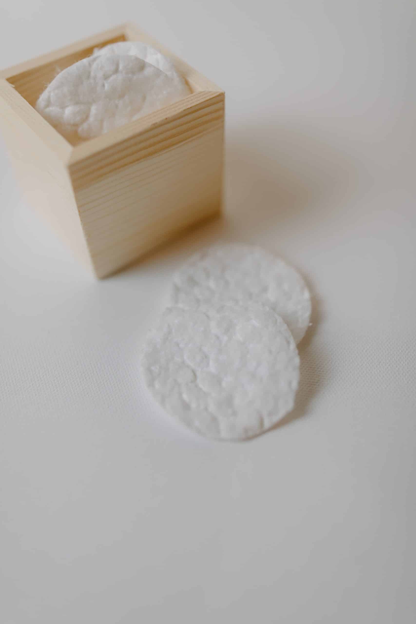 Soft cotton pads stacked in a wooden container