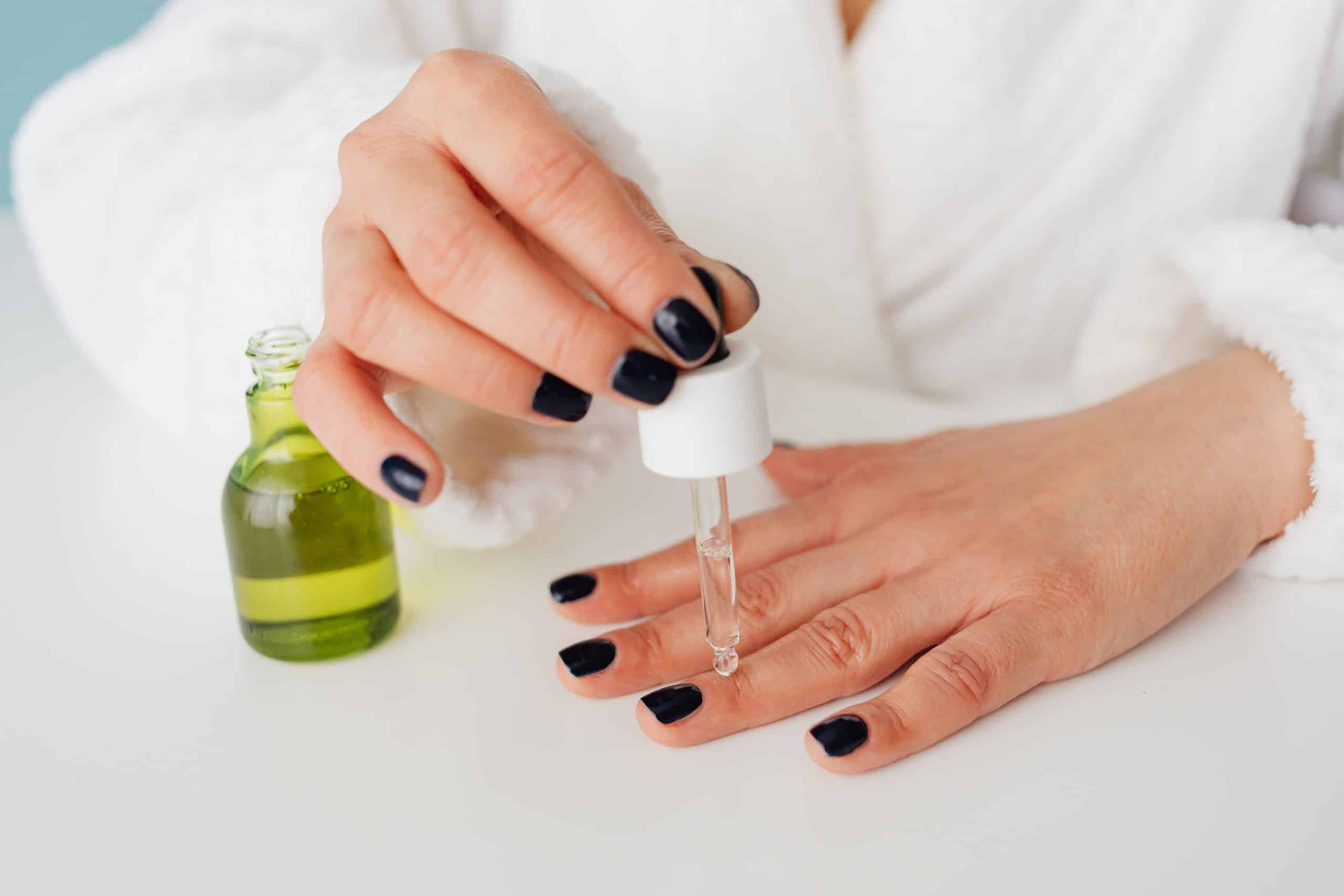 Applying gel nail glue with a dropper applicator