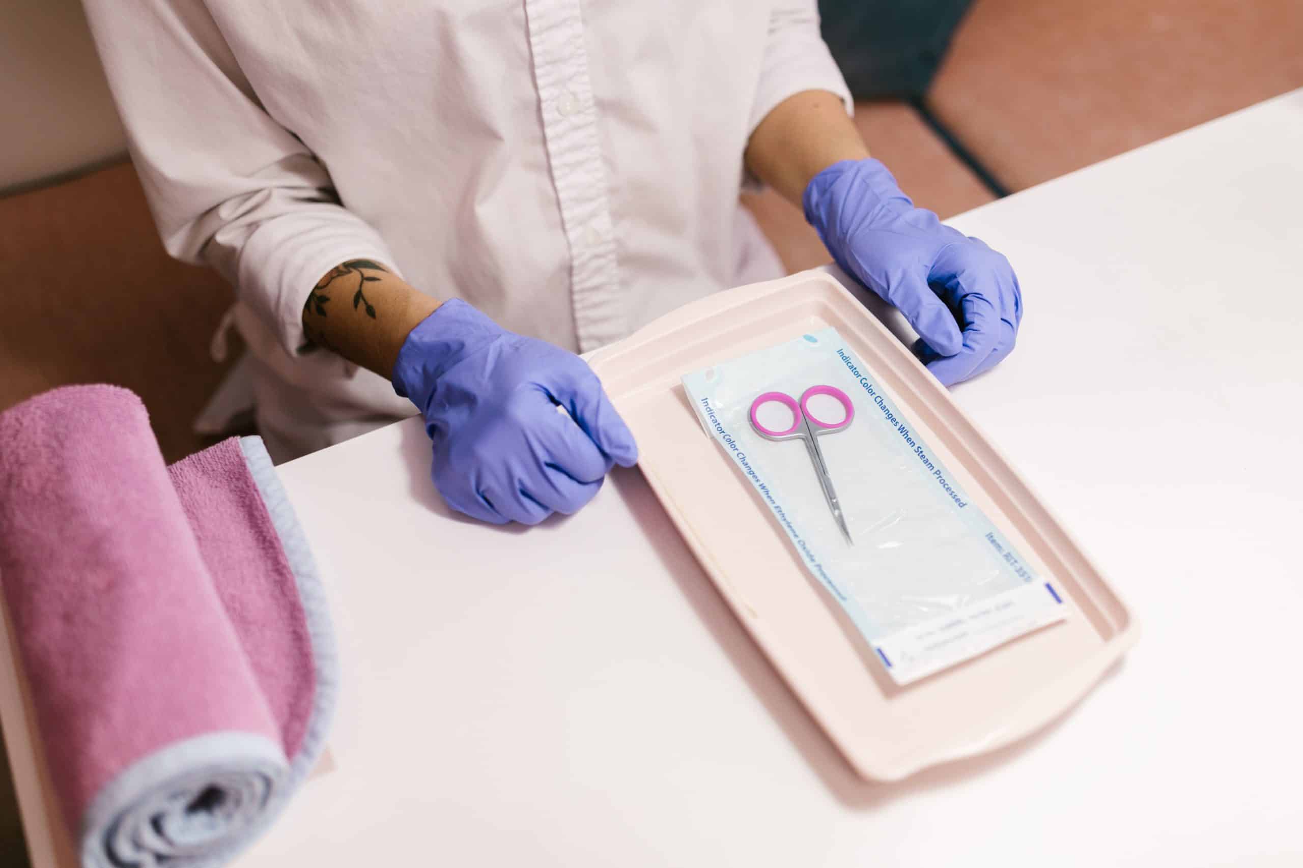 Nail technician preparing sanitized tools between clients