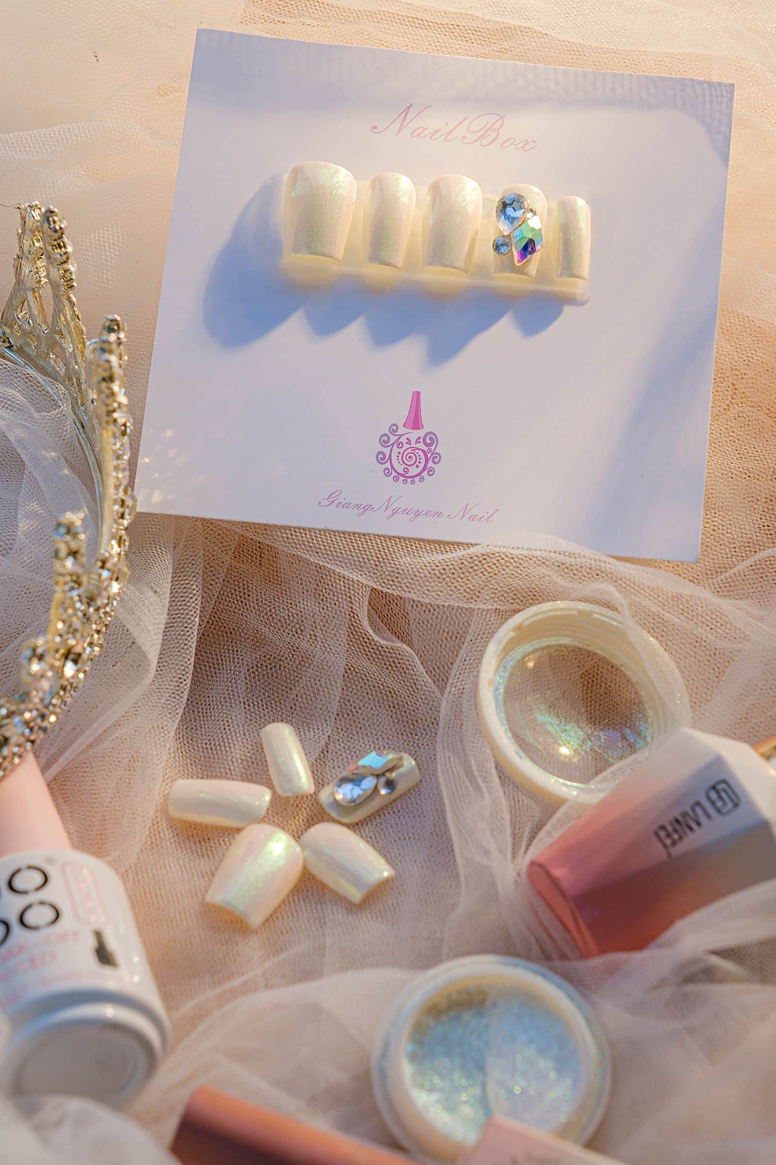 Set of press-on nail tips and accessories arranged on fabric