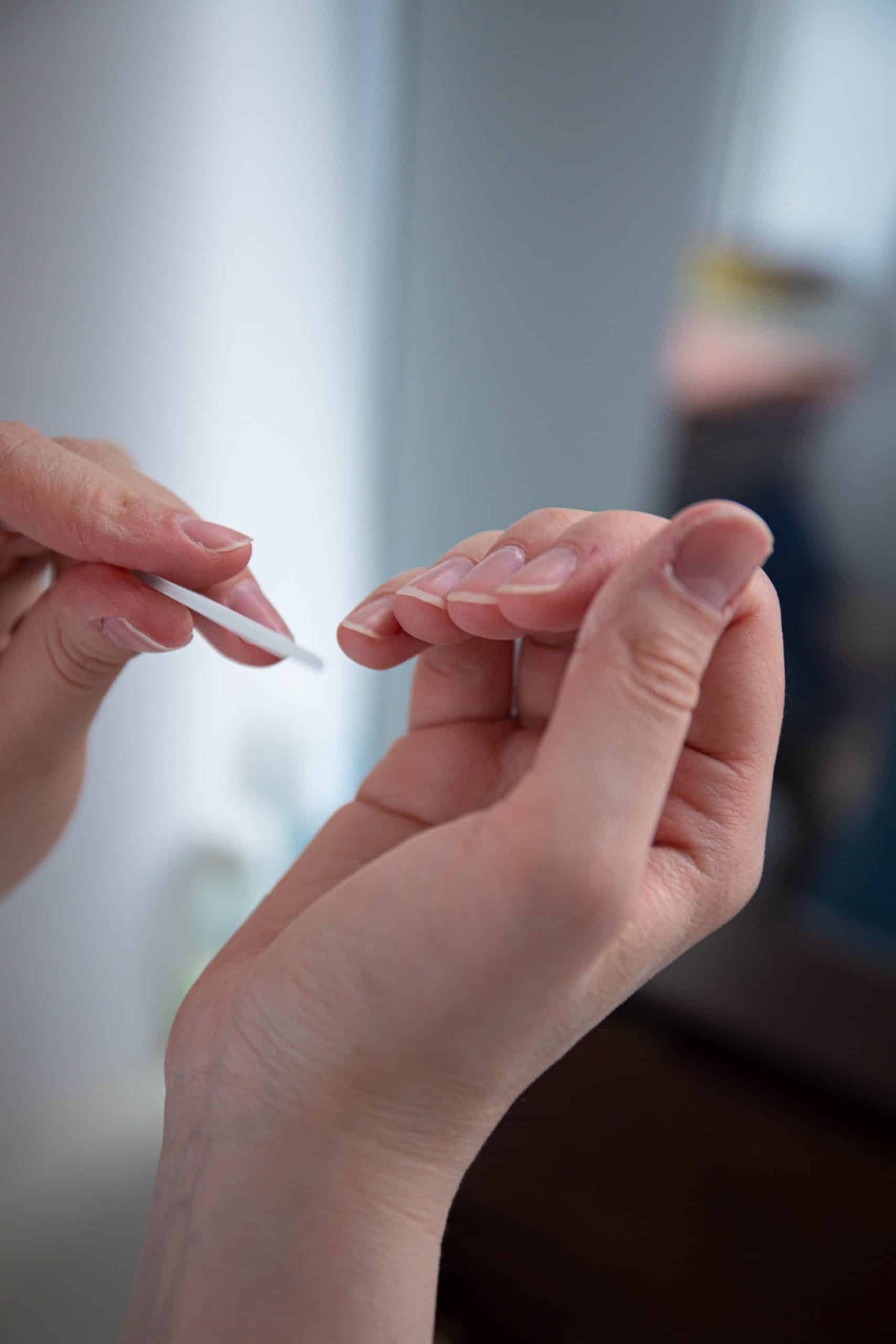 Close-up of hands during a natural nail manicure