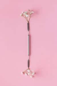 Metal cuticle pusher tool styled with flowers