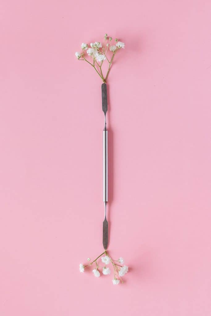Metal cuticle pusher tool styled with flowers