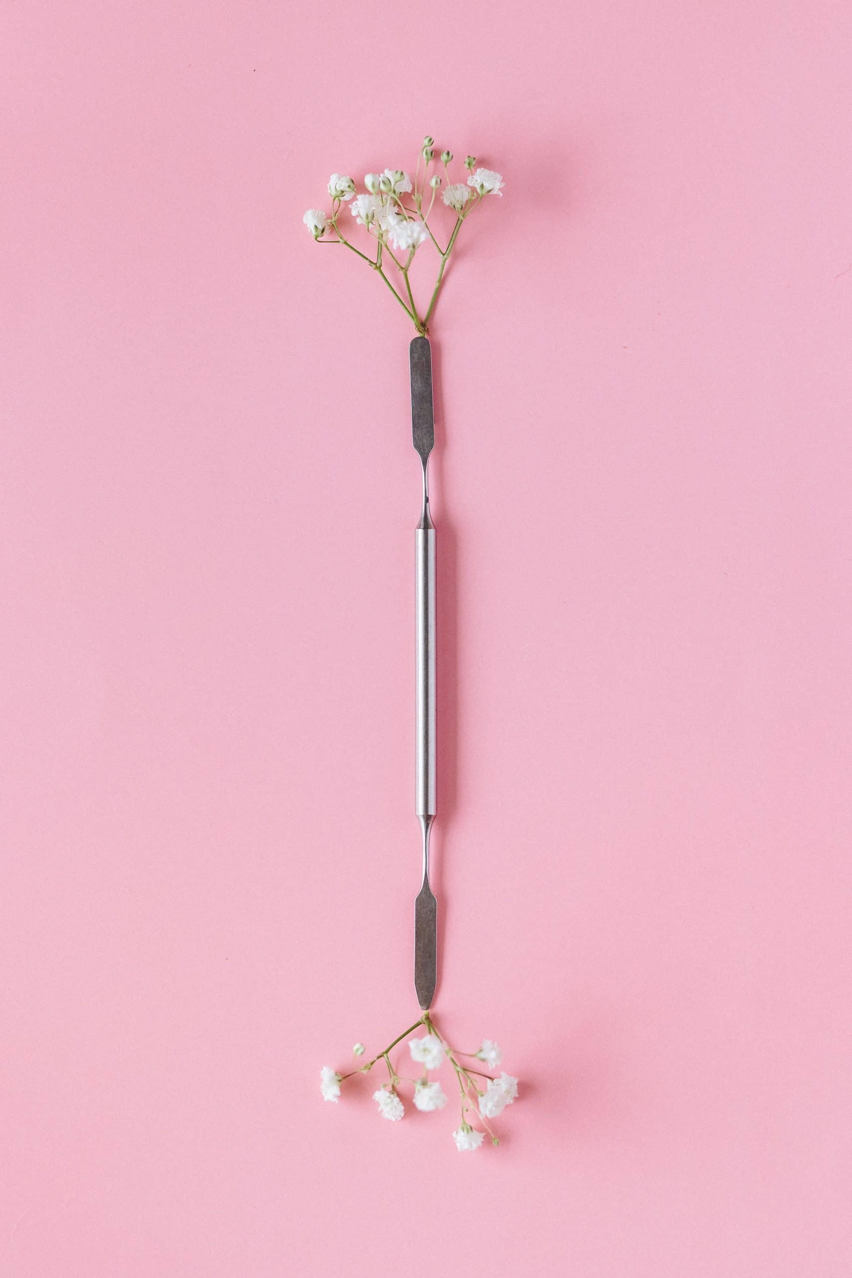 Metal cuticle pusher tool styled with flowers