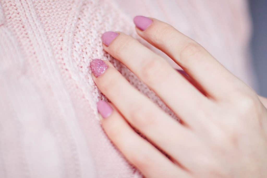 Finished dip powder manicure in a soft pink shade